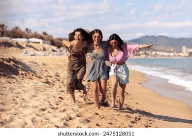 Portrait of three female friends walking on the beach having fun. - Powered by Shutterstock