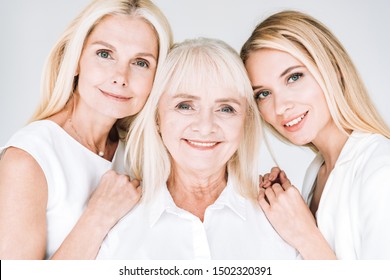 Portrait Of Three Generation Blonde Women Isolated On Grey