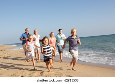 Portrait Of Three Generation Family On Beach Holiday