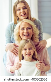 Portrait Of Three Generations Of Happy Beautiful Women Looking At Camera, Hugging And Smiling