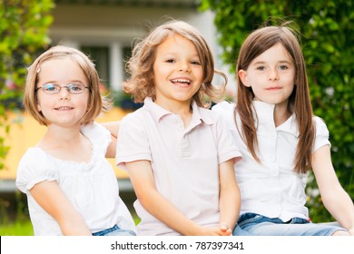 Portrait Of Three Kids In The Garden