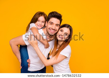 Portrait of three nice attractive lovely cheerful cheery kind tender sweet person having fun weekend holiday mommy daddy day isolated over bright vivid shine yellow background