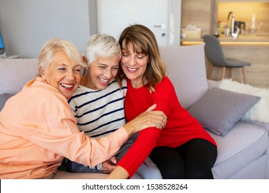 Portrait Of Three Retired Senior Female Friends Sitting On Sofa. Group Of Senior Female Friends Relaxing On Sofa At Home. Three women in living room talking and smiling - Powered by Shutterstock