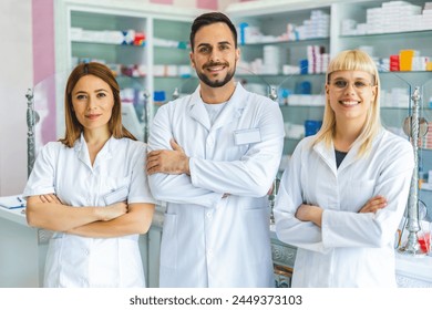 Portrait of three smiling pharmacists that are standing in the pharmacy. - Powered by Shutterstock