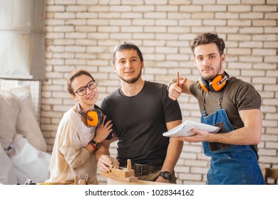 Portrait of three young craftsmen ready to work