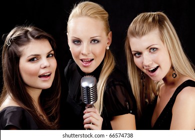 Portrait Of Three Young Women Singing A Song Together