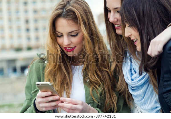 Portrait Three Young Women Using Mobile Stock Photo (Edit Now) 397742131