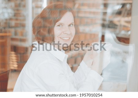 Similar – Young woman looking at cellphone