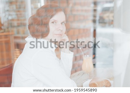 Similar – Young woman looking at cellphone