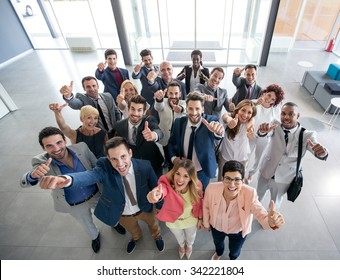 Portrait of thumb up smiling business people 