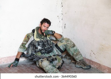 Portrait Of Tired American Soldier Resting From Military Operation; Looking At Camera; Indoor Ruins Location