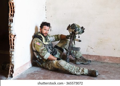 Portrait Of Tired American Soldier Resting From Military Operation; Looking At Camera; Indoor Ruins Location