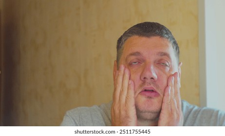 Portrait of tired depressed middle-aged man. The impact of stress on the life of a modern person. Emotionally depressed upset man tries to bring himself back to normal. Close-up.