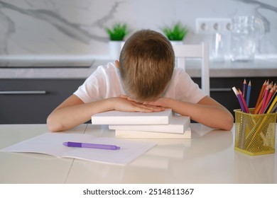 Portrait of tired, sad boy falling asleep at table while doing homework. Child concentrates and focuses on task for elementary school. Back to school. Homeschooling concept. - Powered by Shutterstock