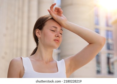 portrait of tired sick exhausted woman, beautiful girl is suffering from hot Summer heat stroke, sunshine, hot weather day, sweaty and thirsty, high temperature. Feeling unwell, unhealthy - Shutterstock ID 2180228219