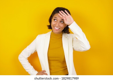 Portrait Of Tired Stylish Woman Isolated Over Yellow Background Gives Deep Sigh Holding Hand On Forehead, Feels Relief After Having A Big Problem At Work