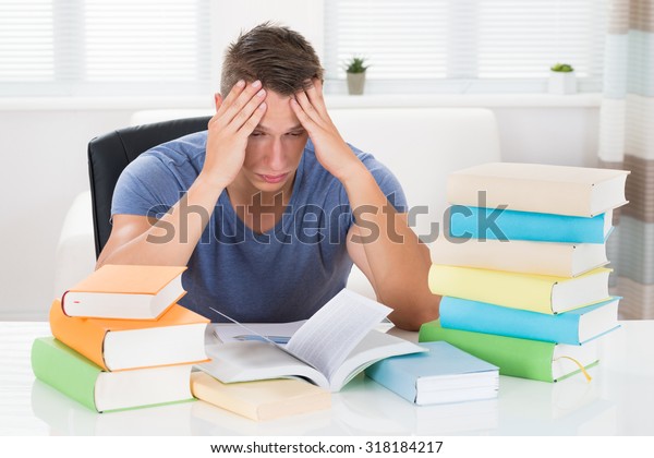 Portrait Tired Young Man Studying Books Stock Photo (Edit Now) 318184217