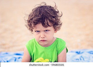 Portrait Of Toddler Boy With Angry Upset Face Expression