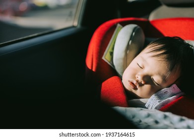 Portrait Of Toddler Boy Sleeping In Car Seat