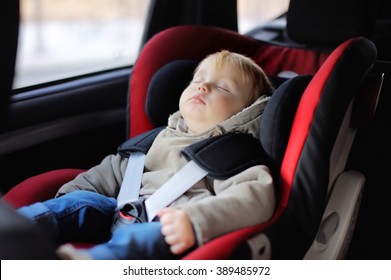 Portrait Of Toddler Boy Sleeping In Car Seat