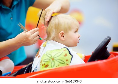 Portrait of toddler child getting his first haircut