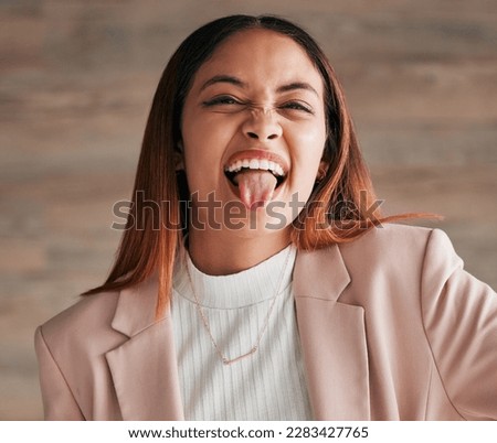 Portrait, tongue and funny face with a woman on a wooden background in studio for comedy, humor or a joke. Comic, crazy and goofy with an attractive young female acting carefree, playful or silly