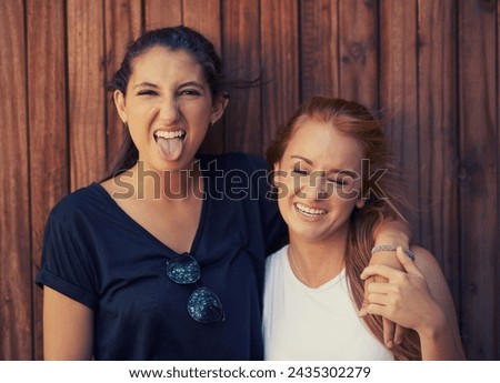Portrait, tongue out and woman friends on wooden background together for bonding or relationship. Love, funny face or laughing and happy young people having fun with fashion in summer for holiday