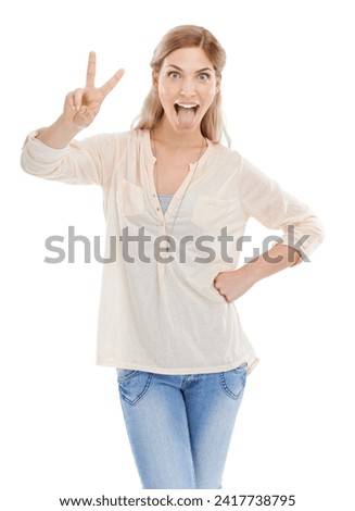 Portrait, tongue and peace sign with excited woman in studio isolated on white background for humor. Emoji, energy or comedy and confident young comic feeling silly or goofy with weird body language