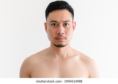 Portrait Of Topless Asian Man With Serious Face On Isolated Background.