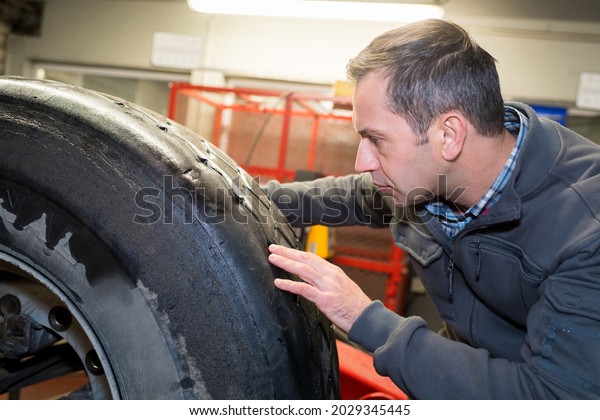 portrait of tractor tire check\
up