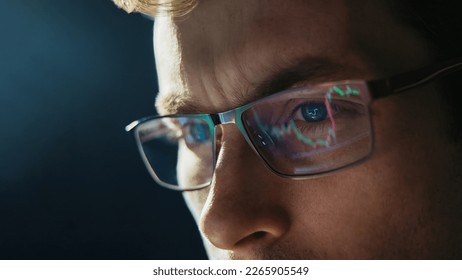 Portrait of trader wearing eyeglasses with reflection cryptocurrency chart. Close-up portrait of man analysing stock market. Copy space - Shutterstock ID 2265905549