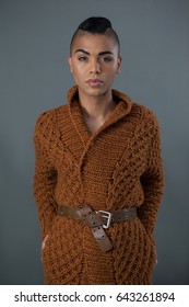 Portrait Of Transgender Woman Standing Over Gray Background