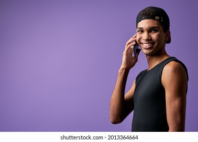 Portrait Of Transgender Young Man Talking Mobile In Black Casual Dress. Latino Trans Gender Model