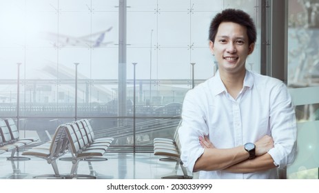 Portrait Of Travel Man Happy Smile And Relaxing At Airport,  Handsome Man Waiting For Flight Aircraft, Airport Terminal Gate For Airplane Travel Trip, Aerospace Industry Flight Connections. Asian Man.