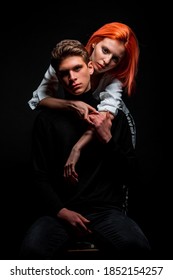 Portrait of trendy stylish young man and redhead woman close to each other