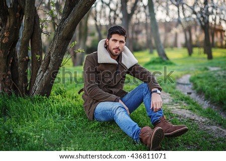 Similar – Thoughtful young man sitting on an urban bench