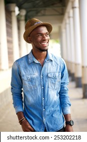 Portrait Of A Trendy Young Man Walking Outside With Hat