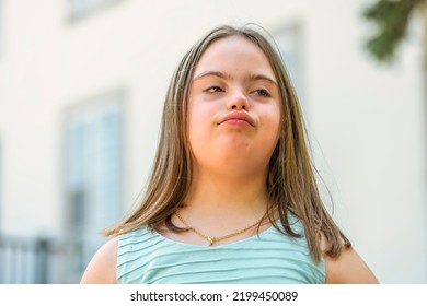 A Portrait Of Trisomy 21 Child Girl Outside On A Park Look Tired