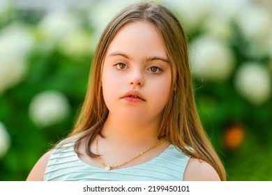 A Portrait Of Trisomy 21 Child Girl Outside On A Park