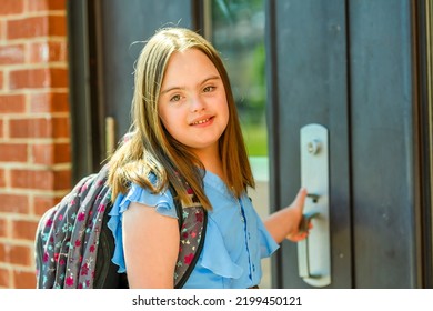 A Portrait Of Trisomy 21 Child Girl Outside On A School Playground