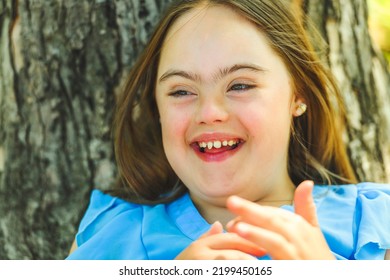 A Portrait Of Trisomy 21 Child Girl Outside Having Fun On A Park