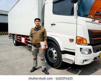 Portrait Of Truck Driver Asian Standing With A White Truck Cargo.