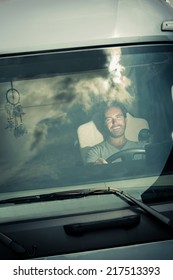 Portrait Of A Truck Driver Sitting In Cab