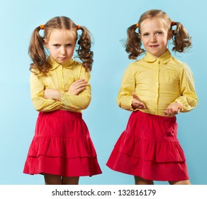 Portrait Of Twin Girls With Opposite Emotions