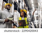 Portrait two african american engineer team shipping order detail on tablet check goods and supplies on shelves with goods inventory in factory warehouse.logistic industry and business export