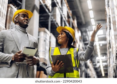 Portrait two african american engineer team shipping order detail on tablet check goods and supplies on shelves with goods inventory in factory warehouse.logistic industry and business export - Powered by Shutterstock