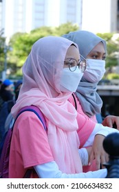 A Portrait Of Two Asian Girls With Pink Sport Attires Not Looking At The Camera