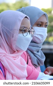 A Portrait Of Two Asian Girls With Pink Sport Attires Not Looking At The Camera