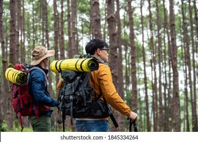 Portrait of Two Asian man friends hiking together in autumn forest. Male couple backpacker walking on mountain trail. Healthy outdoor lifestyle, friendship and holiday vacation concept. - Powered by Shutterstock