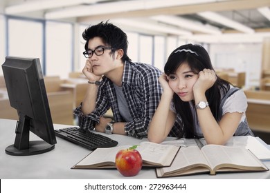 Portrait of two asian students bored in the class room - Powered by Shutterstock